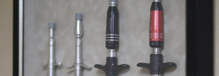 A close-up view of handheld chiropractic adjusting instruments, commonly used for targeted spinal corrections.