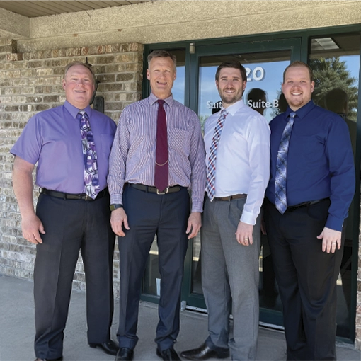 Dr. James R. Boots. Dr. William J. Boots, Dr. Matthew J. Boots and Dr. Kevin J. Boots in the entrance of the clinic.